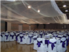 The reception hall is decorated in flowers and bows for a wedding