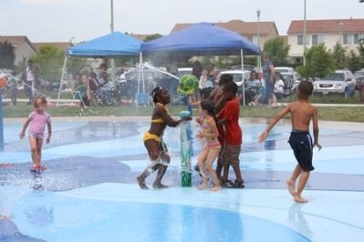 Children playing in a water feature at a sprayground park