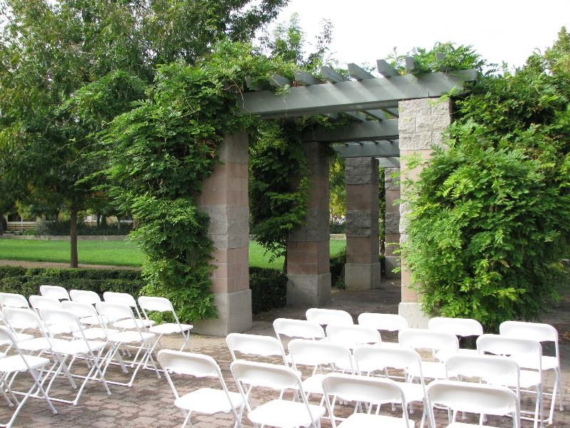 Chairs and flowers are placed in the courtyard for a wedding ceremony