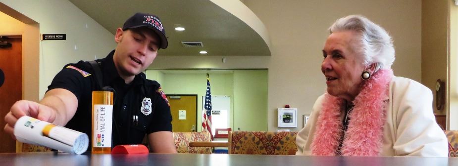 Firefighter educating a citizen about the vial of life program