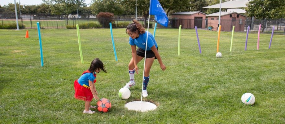 A child learns how to play soccer