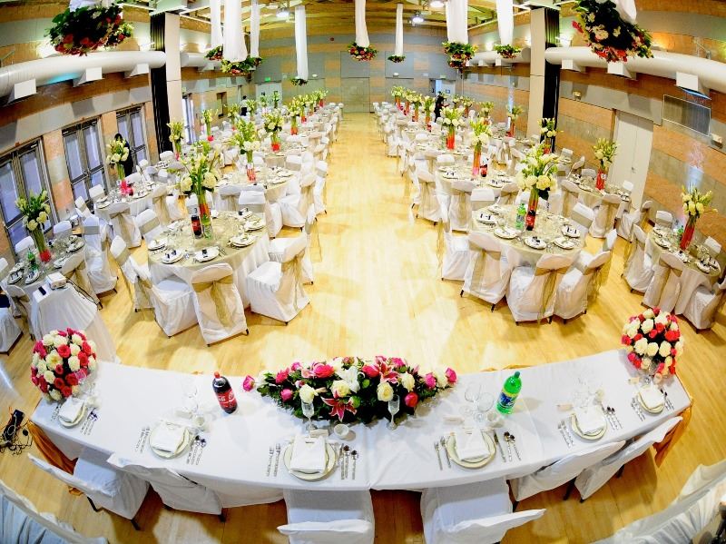The reception hall is decorated in flowers and streamers for a wedding
