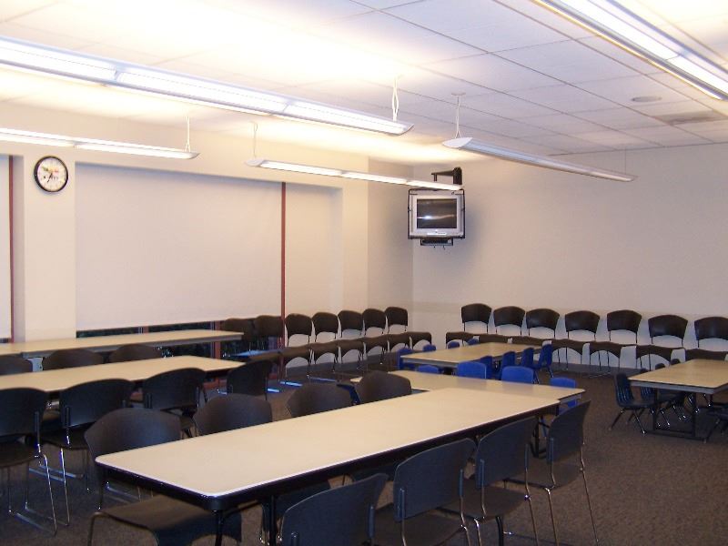 Tables and chairs are set up for a business meeting