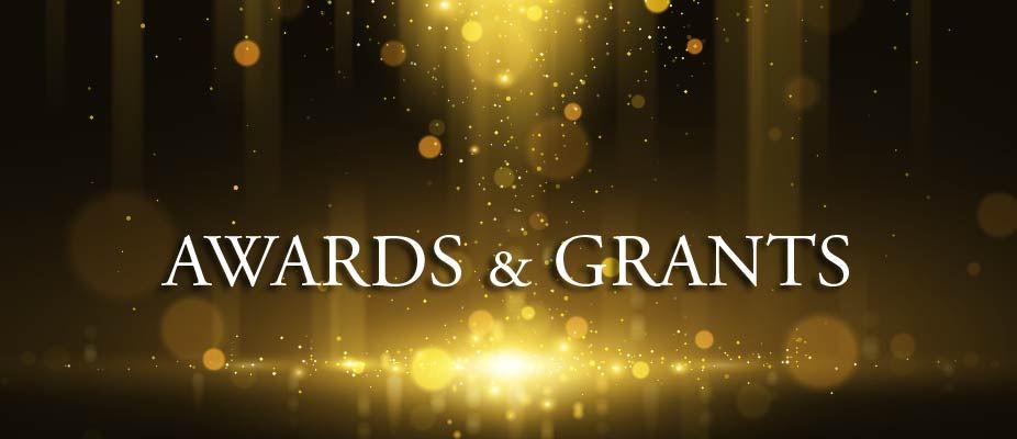 Awards & Grand heading with Bokeh lights background.