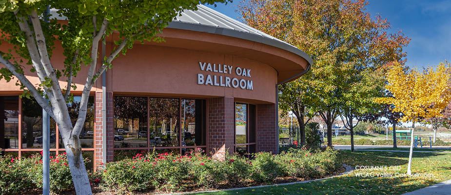 Valley Oak building surrounded by shrubs, lawn and trees.