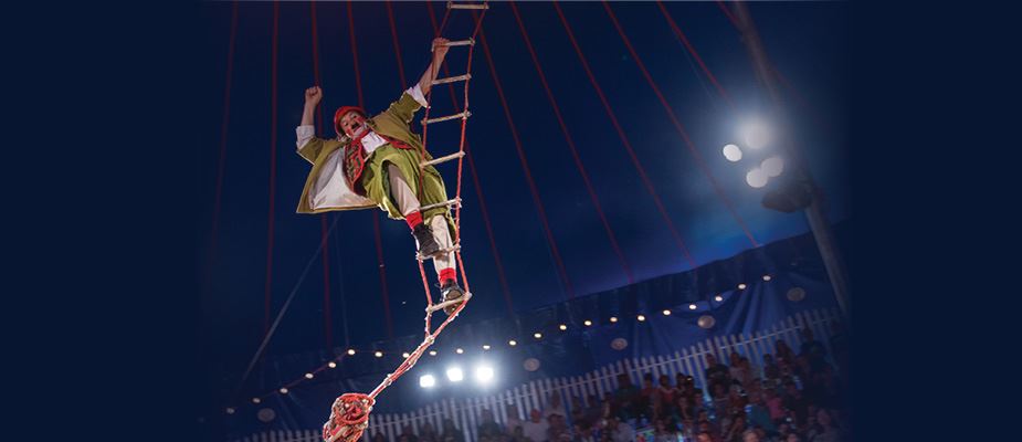 Zoppe Circus Clown on a rope ladder suspended in the air