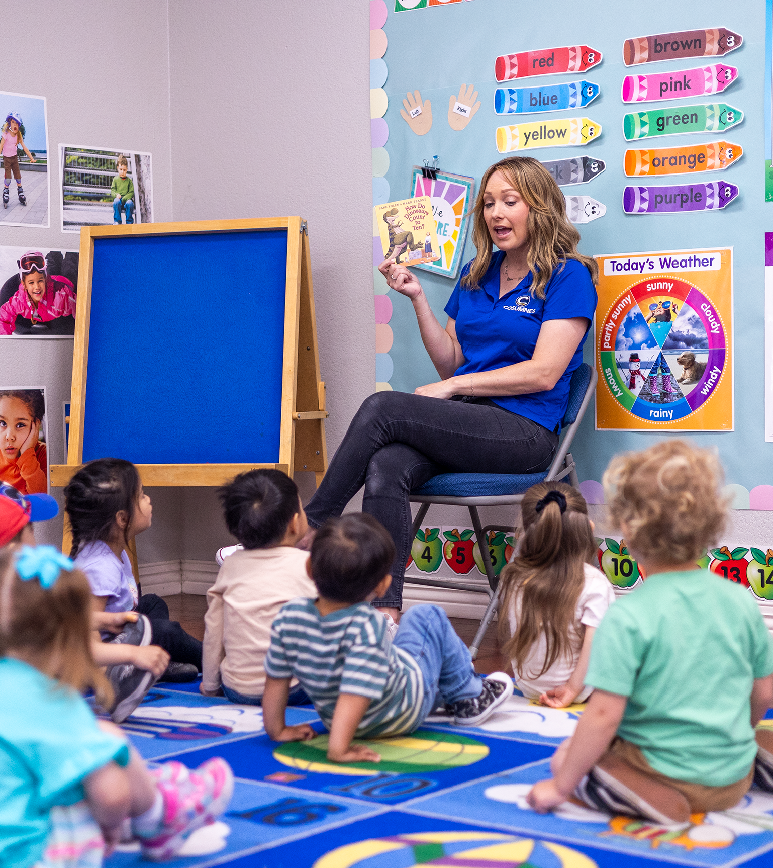 A preschool teacher reads a book to her students.