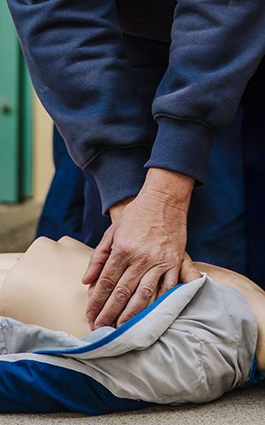Person performing CPR on a manikin