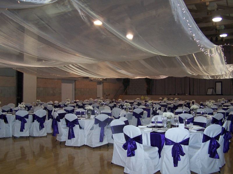 The reception hall is decorated in flowers and bows for a wedding