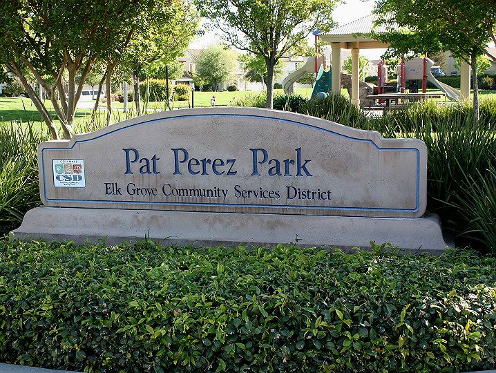 Perez Park sign with green bushes and trees